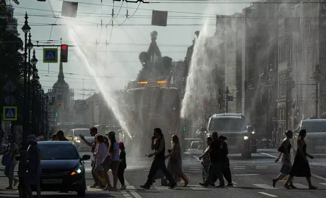 A truck sprays water during a hot day in central St. Petersburg, Russia, Friday, July 31, 2026. (AP Photo/Dmitri Lovetsky)