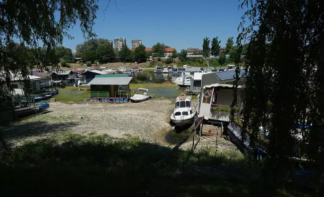 Boats sit on dry ground as water levels have dropped on the Danube River in Novi Sad, Serbia, Wednesday, July 29, 2026. (AP Photo/Darko Vojinovic)