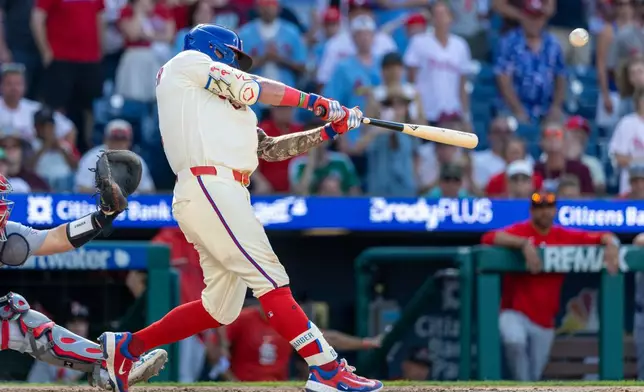 Philadelphia Phillies' Kyle Schwarber hits the winning home run in the ninth inning of a baseball game against the St. Louis Cardinals, Sunday, Aug. 23, 2026, in Philadelphia. (AP Photo/Laurence Kesterson)