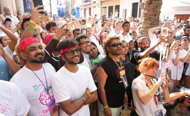 Revelers ahead of the annual "Tomatina" tomato fight fiesta, in the village of Bunol near Valencia, Spain, Wednesday, Aug. 26, 2026. (AP Photo/Alberto Saiz)