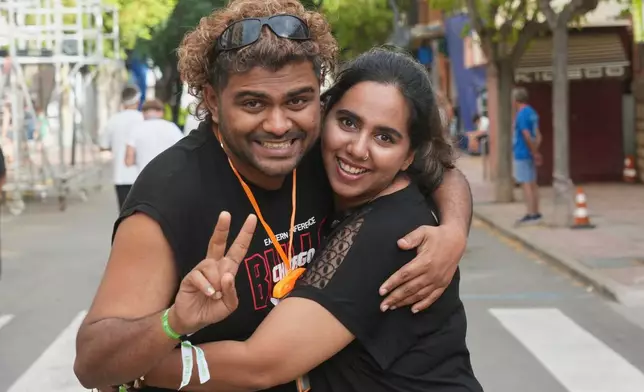 Revelers Vigu, left, and Megha from India pose for a picture ahead of the annual "Tomatina" tomato fight fiesta, in the village of Bunol near Valencia, Spain, Wednesday, Aug. 26, 2026. (AP Photo/Alberto Saiz)