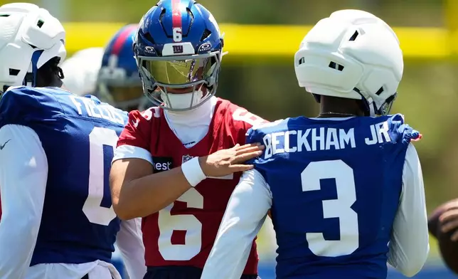 New York Giants quarterback Jaxson Dart greets Odell Beckham Jr. at practice during an NFL football training camp, Friday, July 31, 2026, in White Sulphur Springs, W.Va. (AP Photo/Chris Carlson)