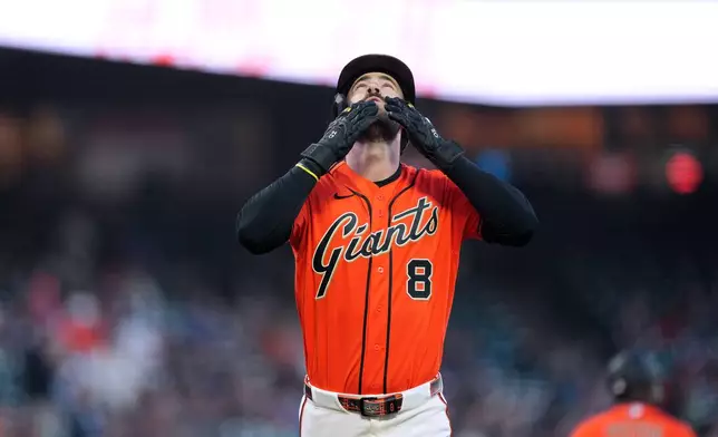San Francisco Giants' Bryce Eldridge gestures as he crosses home plate after hitting a home run against the Arizona Diamondbacks during the first inning of a baseball game in San Francisco, Friday, Aug. 28, 2026. (AP Photo/Tony Avelar)