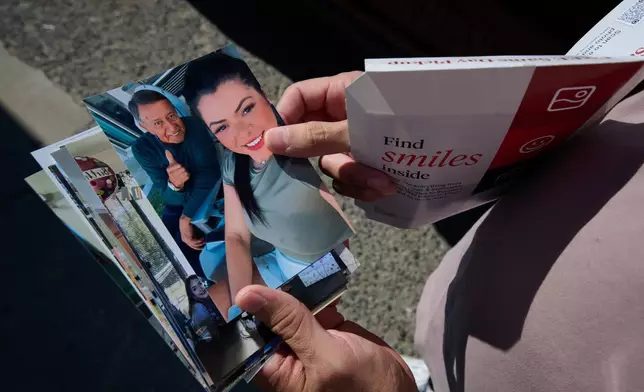 Army Staff Sgt. Alexis Jaramillo shows photos of his wife, Maisa Lopes Eliaser, a Brazilian national who is detained by ICE, near the South Louisiana ICE Processing Center where she is currently held, in Basile, La., Sunday, Aug. 2, 2026. (AP Photo/Joseph Vidrine)