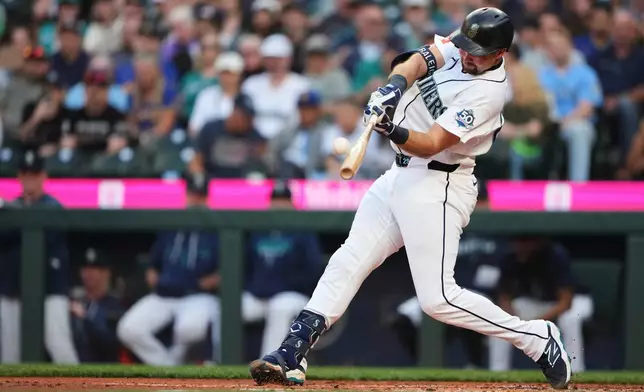 Seattle Mariners' Cal Raleigh hits a two-run home run against the Philadelphia Phillies during the first inning of a baseball game, Monday, Aug. 24, 2026, in Seattle. (AP Photo/Lindsey Wasson)