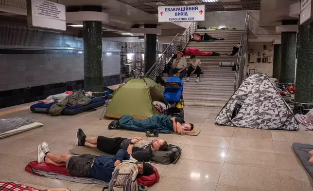 People take shelter in a metro station during a night Russian attack, in Kyiv, Ukraine, early Thursday, Aug. 20, 2026. (AP Photo/Danylo Antoniuk)