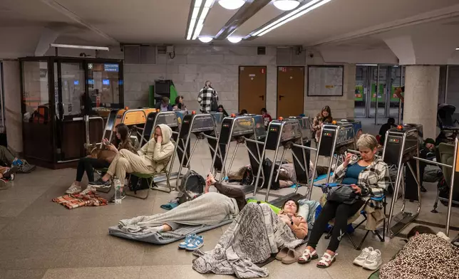 People take shelter in a metro station during a night Russian attack, in Kyiv, Ukraine, early Thursday, Aug. 20, 2026. (AP Photo/Danylo Antoniuk)