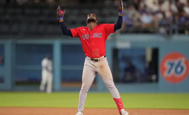 Boston Red Sox's Andruw Monasterio gestures after hitting a two RBI double during the seventh inning of a baseball game against the Los Angeles Dodgers, Friday, July 31, 2026, in Los Angeles. (AP Photo/Mark J. Terrill)