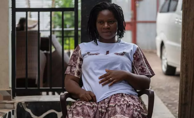 Esther Lutula, a 26 year-old woman who is four months pregnant and a mother of four, sits outside her house in Bunia, northeastern, Congo, Tuesday, June 16, 2026. (AP Photo/Moses Sawasawa)