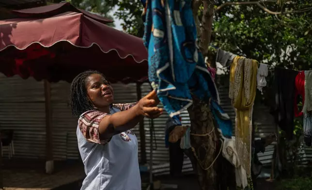 Esther Lutula, a 26 year-old woman who is four months pregnant and a mother of four who stopped going for prenatal checkups shortly after the current Ebola outbreak, does the laundry outside her house in Bunia, northeastern, Congo, Tuesday, June 16, 2026. (AP Photo/Moses Sawasawa)