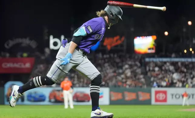 Colorado Rockies' Zac Veen flips his bat after hitting a two-run home run against the San Francisco Giants during the sixth inning of a baseball game, Friday, Aug. 14, 2026, in San Francisco. (AP Photo/Jeff Chiu)