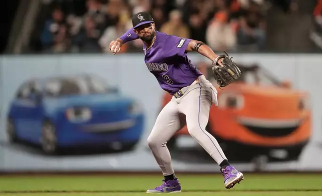 Colorado Rockies third baseman Willi Castro throws out San Francisco Giants' Osleivis Basabe at first base during the seventh inning of a baseball game, Friday, Aug. 14, 2026, in San Francisco. (AP Photo/Jeff Chiu)