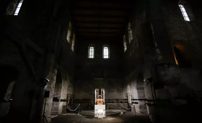 FILE - The organ of the John Cage organ project is illuminated prior to a 'sound change' at the Buchardi Church in Halberstadt, Germany, Sept. 5, 2020. (AP Photo/Markus Schreiber, File)