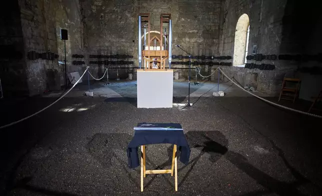 A new pipe for the John Cage Organ Project Halberstadt is placed in front of the organ prior to a chord change of the organ inside the medieval Burchardi Church in Halberstadt, Germany, Wednesday, Aug. 5, 2026. (AP Photo/Markus Schreiber)