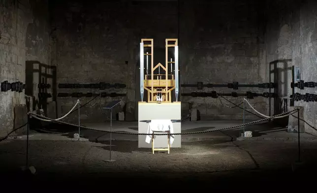FILE - The organ of the John Cage organ project is illuminated prior to a 'sound change' at the Buchardi Church in Halberstadt, Germany, Sept. 5, 2020. (AP Photo/Markus Schreiber, File)