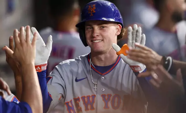 New York Mets right fielder Carson Benge celebrates with teammates in the dugout after hitting a home run during the fifth inning of a baseball game against the Chicago White Sox in Chicago, Saturday, Aug. 22, 2026. (AP Photo/Jessie Alcheh)