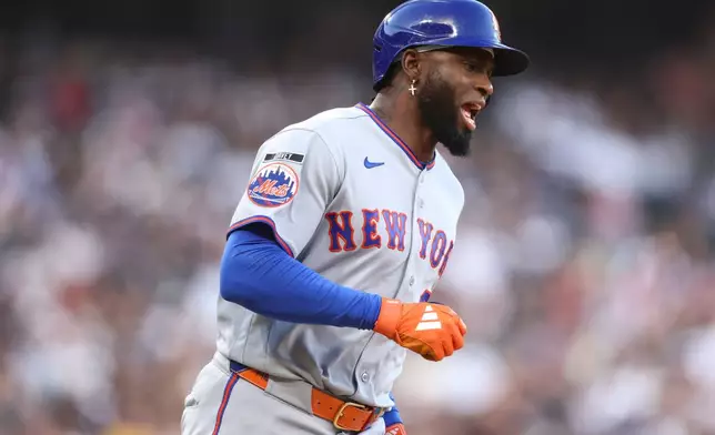 New York Mets' Luis Robert Jr. reacts after hitting a home run during the third inning of a baseball game against the Chicago White Sox in Chicago, Saturday, Aug. 22, 2026. (AP Photo/Jessie Alcheh)