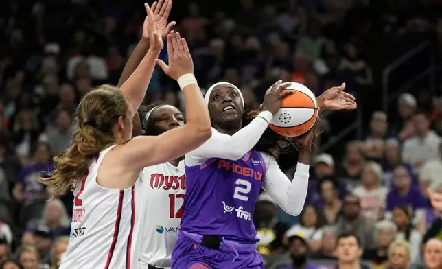 Phoenix Mercury guard-forward Kahleah Copper (2) drives to the basket against Washington Mystics guard Alicia Florez, left, and Mystics forward Michaela Onyenwere (12) during the first half of a WNBA basketball game, Thursday, Aug. 27, 2026, in Phoenix. (AP Photo/Ross D. Franklin)