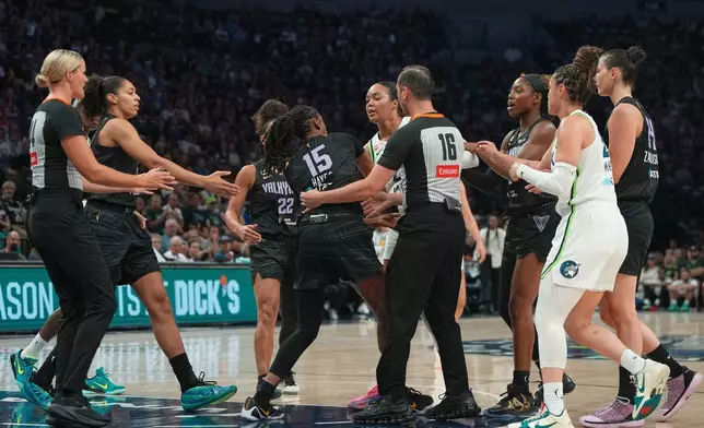 Minnesota Lynx forward Napheesa Collier, center right, and Golden State Valkyries guard Tiffany Hayes (15) get into an altercation during the first half of a WNBA basketball game Monday, Aug. 24, 2026, in Minneapolis. (AP Photo/Abbie Parr)