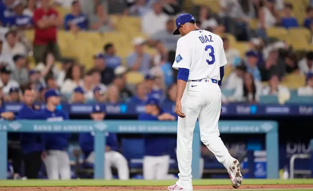 Los Angeles Dodgers pitcher Edwin Díaz walks off the field after being taken out of the game during the ninth inning of a baseball game against the Milwaukee Brewers, Thursday, Aug. 13, 2026, in Los Angeles. (AP Photo/Mark J. Terrill)