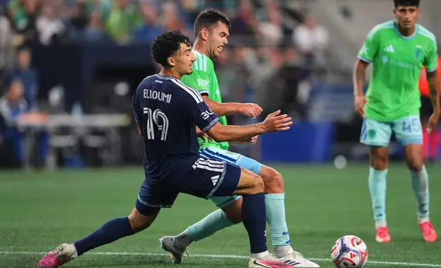 Seattle Sounders defender Jackson Ragen clears the ball from Vancouver Whitecaps forward Rayan Elloumi (19) during the first half of an MLS soccer match, Sunday, Aug. 16, 2026, in Seattle. (AP Photo/Lindsey Wasson)
