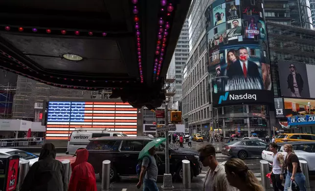 People walk past the Nasdaq MarketSite, Thursday, Aug. 6, 2026, in New York. (AP Photo/Yuki Iwamura)