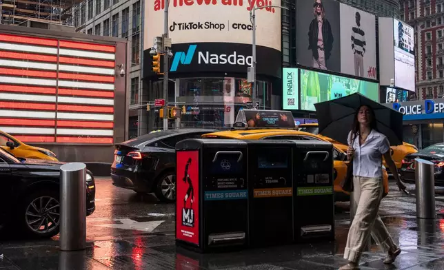 People walk past the Nasdaq MarketSite, Thursday, Aug. 6, 2026, in New York. (AP Photo/Yuki Iwamura)