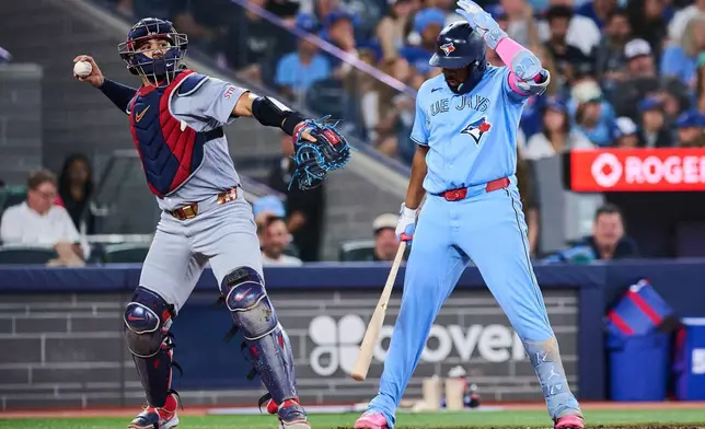 Toronto Blue Jays' Vladimir Guerrero Jr., right, unsuccessfully challenges a strike call during the fourth inning of a baseball game against the St. Louis Cardinals in Toronto, Sunday, Aug. 2, 2026. (Sammy Kogan/The Canadian Press via AP)