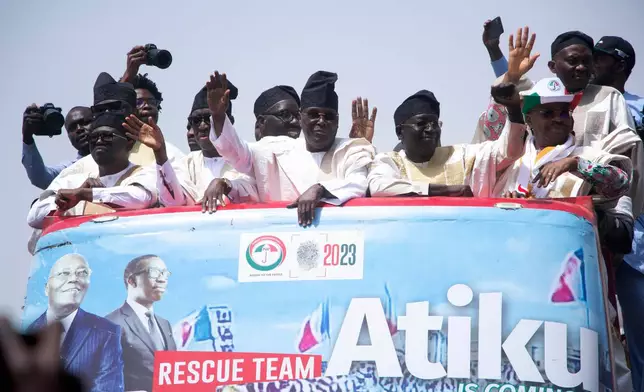 FILE- Atiku Abubakar, former presidential candidate of the People's Democratic party, and now Presidential Candidate of the African Democratic Congress, Nigeria's opposition party, Center, waves to his supporters during a presidential election campaign rally in Yola Nigeria, Saturday, Feb. 18, 2023. (AP Photo/Radeno Haniel, File)