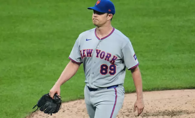 New York Mets pitcher Robert Stock walks off the mound after handing the ball to manager Andy Green during the fourth inning of a baseball game against the Pittsburgh Pirates in Pittsburgh, Saturday, Aug. 8, 2026. (AP Photo/Gene J. Puskar)