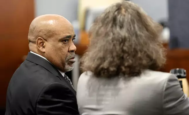 Duane Davis, left, listens to his attorney Michael Sanft during Davis' murder trial, related to the 1996 killing of rapper Tupac Shakur, in Clark County District Court at the Regional Justice Center in Las Vegas, Thursday, Aug. 20, 2026. (Steve Marcus/Pool Photo via AP