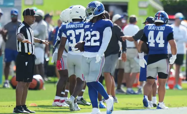 New York Giants running back Najee Harris (22) does drills during a joint NFL football practice with the Miami Dolphins, Thursday, Aug. 20, 2026, in Miami Gardens, Fla. (AP Photo/Lynne Sladky)