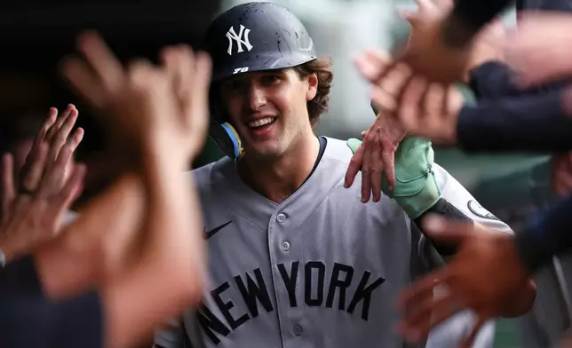 New York Yankees' Spencer Jones celebrates with teammates in the dugout after hitting a home run during the fifth inning of a baseball game against the Chicago Cubs in Chicago, Friday, July 31, 2026. (AP Photo/Jessie Alcheh)