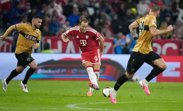 Bayern's Harry Kane, centre, passes the ball during the Bundesliga soccer match between Bayern Munich and VfB Stuttgart in Munich, Germany, Friday, Aug. 28, 2026. (AP Photo/Matthias Schrader)