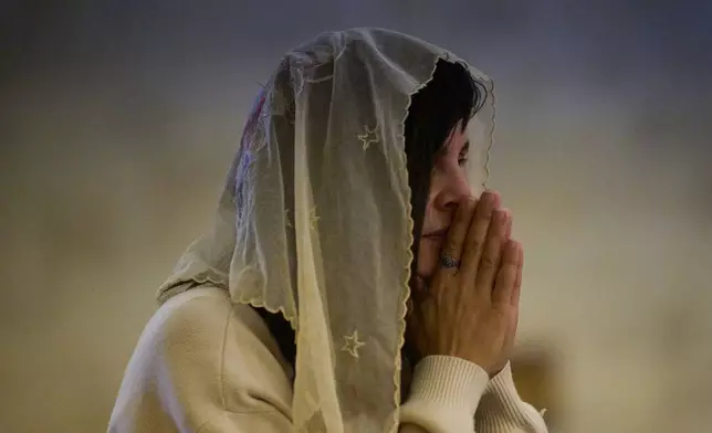 A Christian pilgrim attends a Mass in the Basilica of the Transfiguration on Mount Tabor, northern Israel, Aug. 6, 2026. (AP Photo/Ariel Schalit)