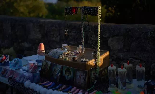 Religious souvenirs for sale are placed on a stand for Christian pilgrims who climb to the Basilica of the Transfiguration on Mount Tabor, northern Israel, on Aug. 6, 2026. (AP Photo/Ariel Schalit)