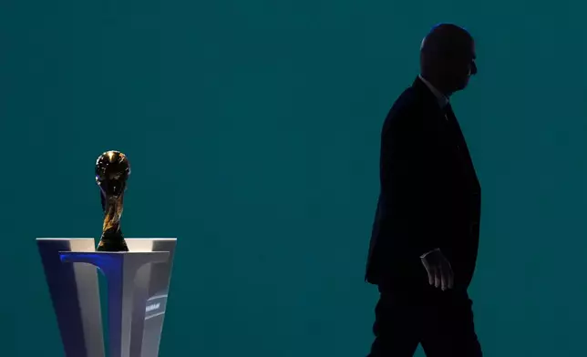 FILE - FIFA President Gianni Infantino is silhouetted as he walks past the World Cup trophy after addressing the 76th FIFA Congress in Vancouver, British Columbia, Thursday, April 30, 2026. (Darryl Dyck/The Canadian Press via AP, File)