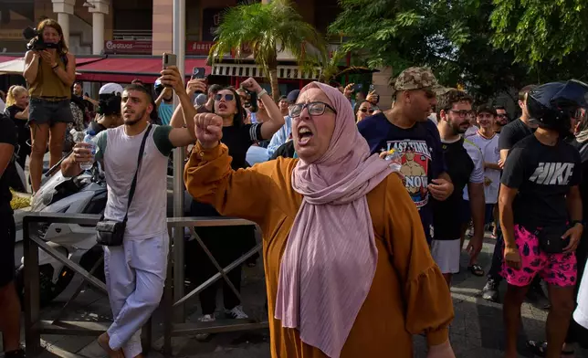 Ceuta residents gather for a counterprotest against a rally by a far-right nationalist and racist movement in the Spanish enclave of Ceuta, Saturday, Aug. 1, 2026. (AP Photo/Bernat Armangue)