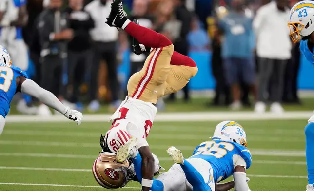 San Francisco 49ers running back Kaelon Black, left, is tackled by Los Angeles Chargers defensive back Avery Smith during the first half of a preseason NFL football game, Thursday, Aug. 20, 2026, in Inglewood, Calif. (AP Photo/Mark J. Terrill)