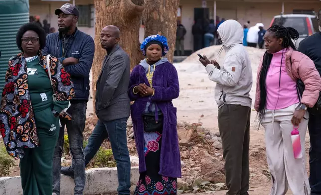 People queue up outside a polling station during a presidential election in Lusaka, Zambia, Thursday, Aug. 13, 2026. (AP Photo/Anita Reed)