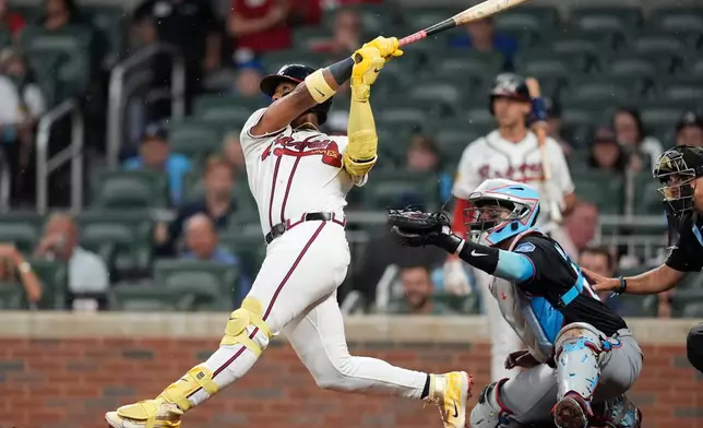 Atlanta Braves' Ronald Acuña Jr. (13) hits a two-run homer against the Miami Marlins in the third inning of a baseball game, Thursday, Aug. 6, 2026, in Atlanta. (AP Photo/Mike Stewart)