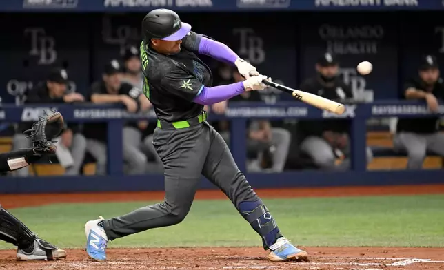 Tampa Bay Rays' Nick Fortes hits an RBI single during the fifth inning of a baseball game against the Chicago White Sox Saturday, Aug. 1, 2026, in St. Petersburg, Fla. (AP Photo/Jason Behnken)
