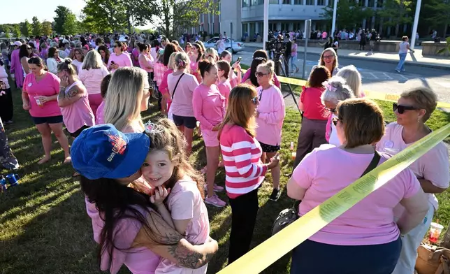 Kara Hurston holds her daughter Prinn, 4, as they join a demonstration in support of Lindsay Clancy outside Plymouth Superior Court, where Clancy is on trial in connection with the deaths of her three children, Thursday, Aug. 20, 2026, in Plymouth, Mass. (AP Photo/Josh Reynolds )