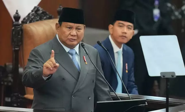 Indonesian President Prabowo Subianto, left, delivers his annual State of the Nation Address as Indonesian Vice President Gibran Rakabuming Raka listens ahead of the country's Independence Day at the parliament building in Jakarta, Indonesia, Friday, Aug. 14, 2026. (AP Photo/Dita Alangkara)