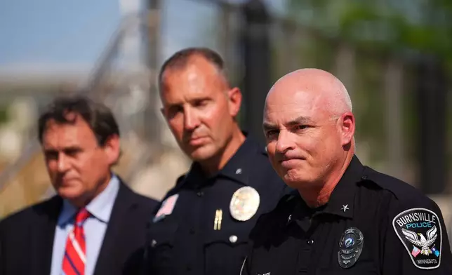Burnsville Police Chief Matt Smith, right, attends a news conference in Hopkins, Minn., Wednesday, Aug. 12, 2026, where police said a man who killed his wife and their 7-year-old daughter at an in-home daycare is also suspected of killing a 78-year-old female relative. (AP Photo/Ellen Schmidt)