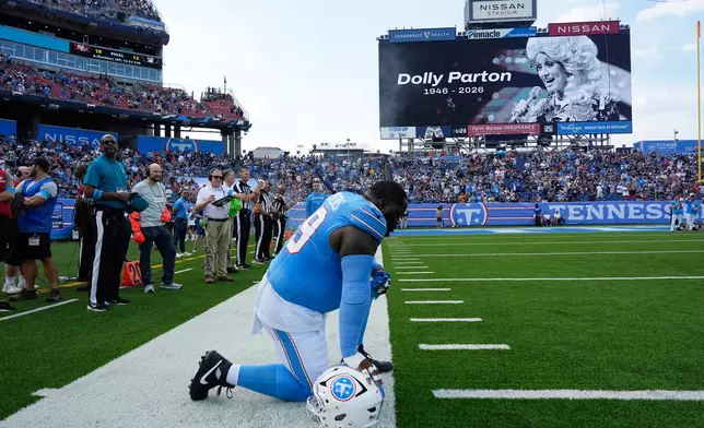 Tennessee Titans defensive tackle Khalen Saunders pauses during a moment of silence for Dolly Parton prior to a preseason NFL football game against the Chicago Bears, Saturday, Aug. 29, 2026, in Nashville, Tenn. (AP Photo/George Walker IV)