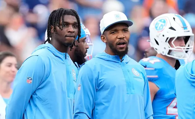 Tennessee Titans quarterback Cam Ward, left, and running back Tony Pollard look on as teammates warm up prior to a preseason NFL football game against the Chicago Bears, Saturday, Aug. 29, 2026, in Nashville, Tenn. (AP Photo/George Walker IV)