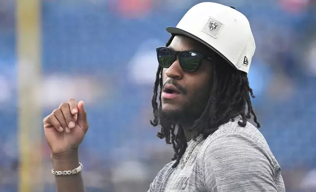 Chicago Bears wide receiver Luther Burden III looks on as teammates warm up prior to a preseason NFL football game against the Tennessee Titans, Saturday, Aug. 29, 2026, in Nashville, Tenn. (AP Photo/John Amis)