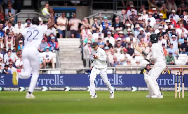 England's Joe Root, center, catches out Pakistan's Azan Awais from the bowling of England's Jofra Archer, left, on day three of the first Test match between England and Pakistan in Leeds, England, Friday Aug. 21, 2026. (Mike Egerton/PA via AP)