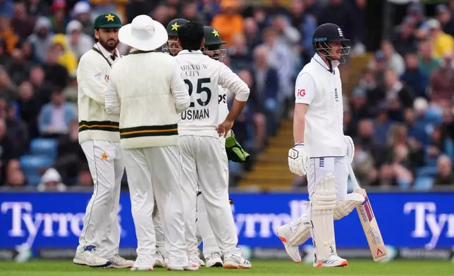 England's Jordan Cox, right, leaves the field after being bowled out by Pakistan's Ali Usman on day two of the first Test match between England and Pakistan in Leeds, England, Thursday Aug. 20, 2026. (Mike Egerton/PA via AP)